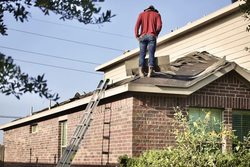 Professional roofer working on a residential roof in Reisterstown Station